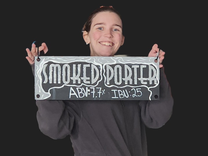 Maddy holding smoked porter sign