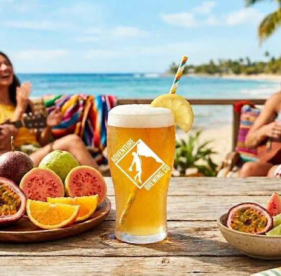 Passion orange guava shandy with people by a beach